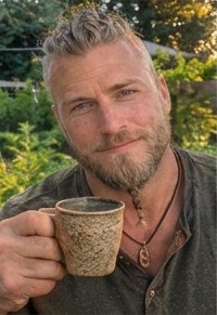 Leif holding a mug of herbal tea